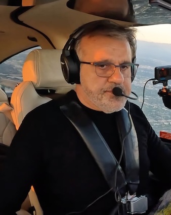 Raffi Alexanian, founder of Age of Counsel, standing beside a small aircraft